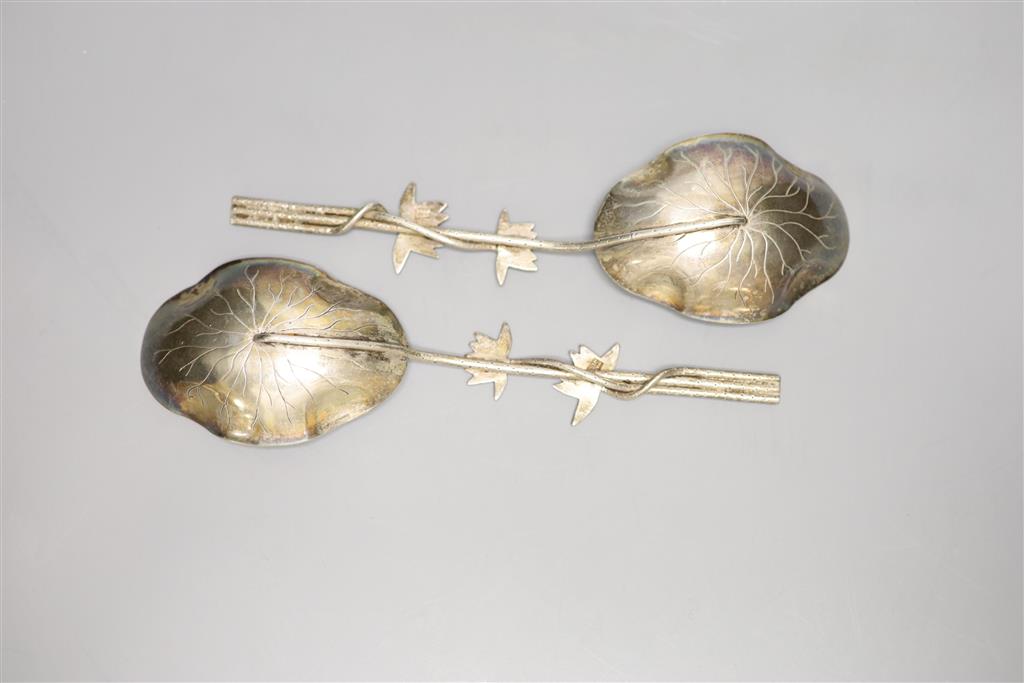 A pair of early 20th century Chinese white metal spoons, with foliate stems, by Wang Hing, 19.3cm, 3 oz.